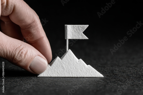 Small mountain white paper finger flag black background texture