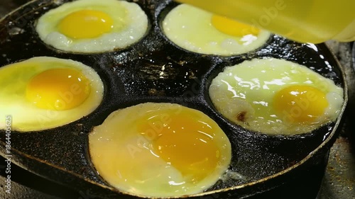a street stall frying eggs at night