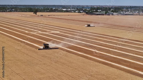 Dust follows combines as they move through dry wheat rows