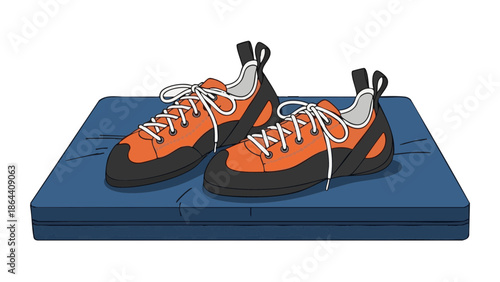 Climbing shoes placed on blue mat for sport activities  