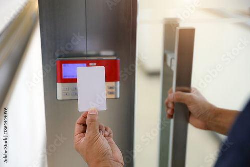 Hand scanning proximity ID card on reader access control system to security door unlock with identity or verification identify icons for safety detect fingerprint scan or check attendance.