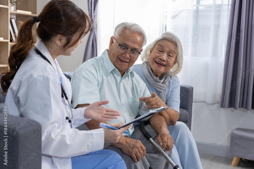 Obraz premium Friendly young female doctor consulting elderly couple sitting on sofa at home explaining health result with happy expression showing professional care support and medical assistance