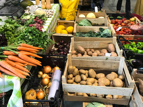 Valokuva Fresh vegetables and fruits arranged on a table at a local market, with no people visible