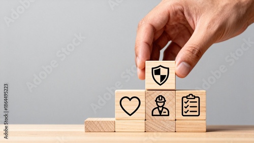 Hand placing block with shield icon on tower