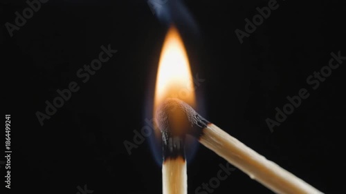 burning match on a black background