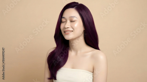 Wallpaper Mural Beautiful young Asian woman with long, vibrant purple hair, smiling serenely with closed eyes against a beige background, showcasing healthy and shiny hair. Torontodigital.ca