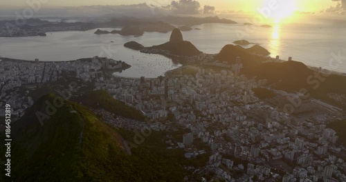 Flying above city of Rio de Janeiro at sunrise. Wide angle panorama of Botafogo Bay and Sugar Loaf Mountain, Brazil
