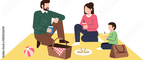 Happy young family with mother father and child enjoying a summer picnic outdoors on a yellow blanket with food basket