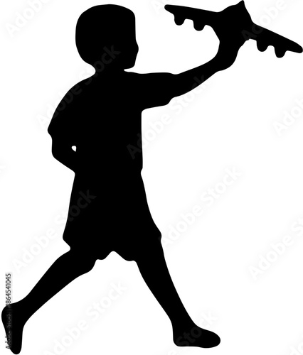 Silhouette of a little boy running and playing with a toy airplane.