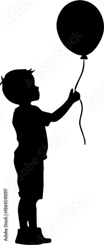 Silhouette of a little boy standing and holding a round balloon