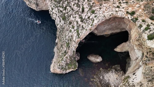 A distant flyby focusing on the Blue Grotto, Malta