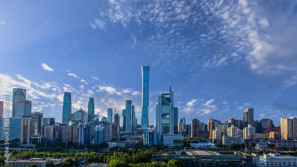 Fototapeta premium Panoramic view of Beijing Central Business District skyline with modern skyscrapers and office buildings under a clear blue sky.