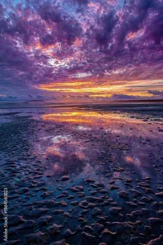 Sunset Over Coastal Beach With Reflections