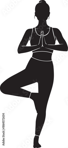 Silhouette of a woman in a yoga tree pose with hands pressed together