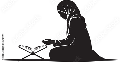 Woman in hijab praying with open book