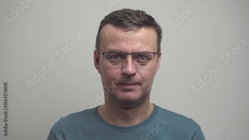 Sullen person is adjusting glasses. Life in glasses