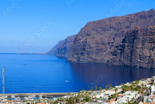Panorama with vertical cliffs of the Giants (Acantilados de Los Gigantes), townscape of Los Gigantes and Atlantic Ocean at Canary Island Tenerife, Spain