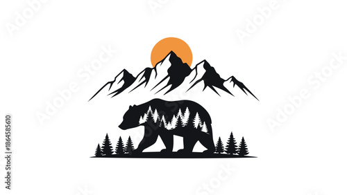 Grizzly bear walking silhouette in front of mountains