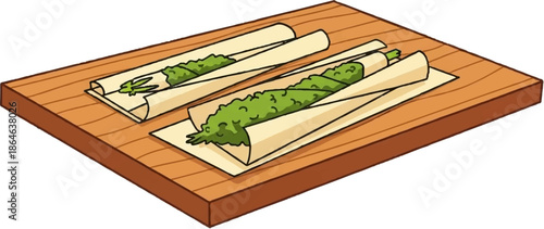 Two green cannabis joints being rolled on a wooden surface