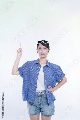 The young girl is photographed against a white background