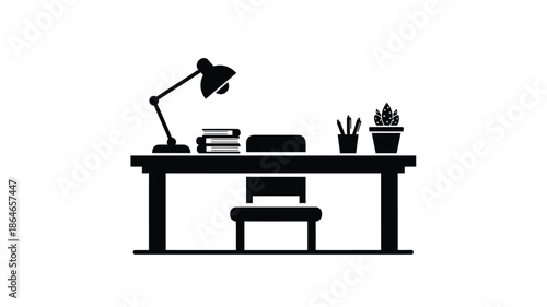 Simple desk setup with lamp books and plant in black silhouette
