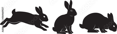 Three silhouetted rabbits in different poses