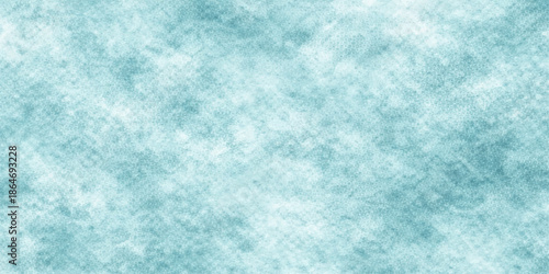 A blue abstract grunge background features a bright winter texture of white frost and crystal snowflakes on a cold frozen surface