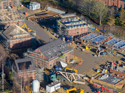 Aerial drone photo of the town of Ripon in North Yorkshire in the UK showing a housing development site building new homes in the autumn time with workmen working on the homes