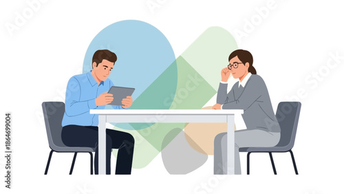 professional business meeting or interview scenario with two people discussing at a table in an