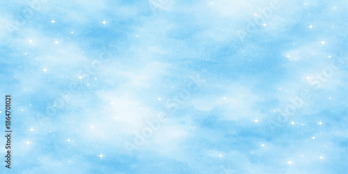 An abstract blue Christmas winter background features bright white snowflakes falling through a beautiful clear sky with fluffy clouds and sunlight for a serene nature atmosphere