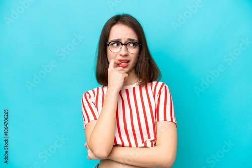 Young Ukrainian woman isolated on blue background nervous and scared