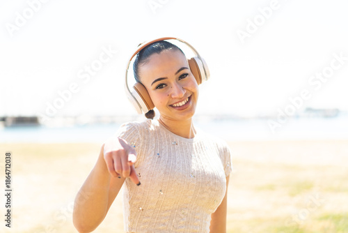 Young moroccan girl  at outdoors listening music