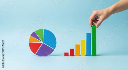 Business Analysis and Growth Hand Arranging Colorful Wood Blocks Pie Chart and Bar Graph Representing Sales Statistics and Profit Analysis