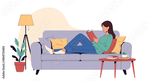 Woman reclining on a lavender sofa while reading a red book in a cozy living room with a lamp and a side table.