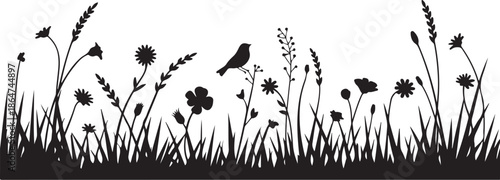 Black silhouette of bird perched on wildflowers in a meadow