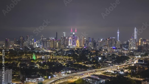 Wallpaper Mural Above a vibrant cityscape, where fountains glow and traffic pulses—Malaysia’s capital in full electric elegance Torontodigital.ca
