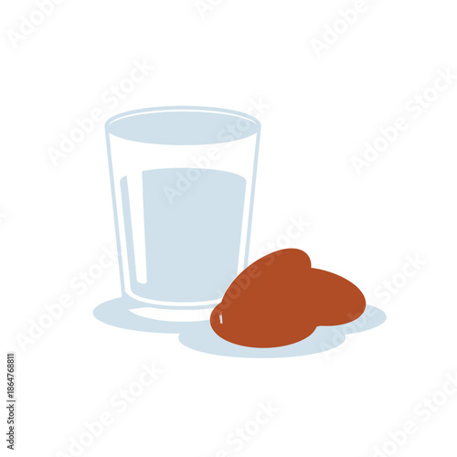 A glass of milk next to two brown cookies on a white background.