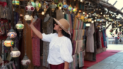 woman shopping for handmade lamps and printed shawls from a street market in Udaipur Rajasthan, handicraft market with tourist