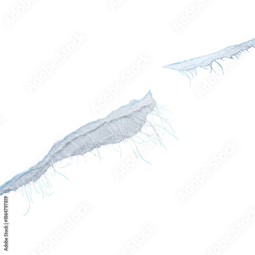 White fibrous material with frayed edges and fine strands against black background texture