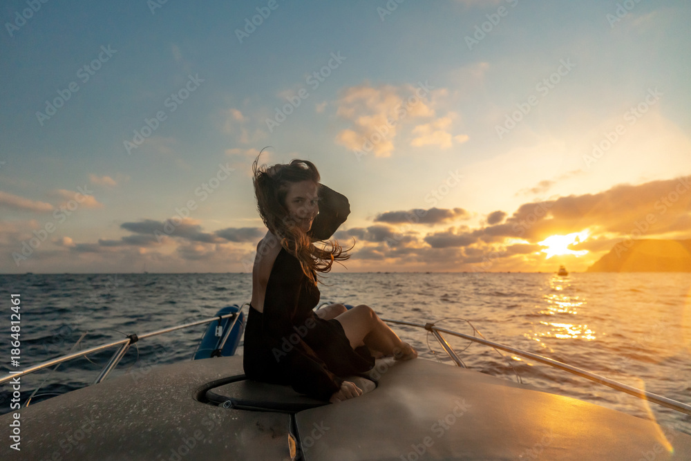 © svetograph - Woman boat sunset smiling on yacht during beautiful ocean evening