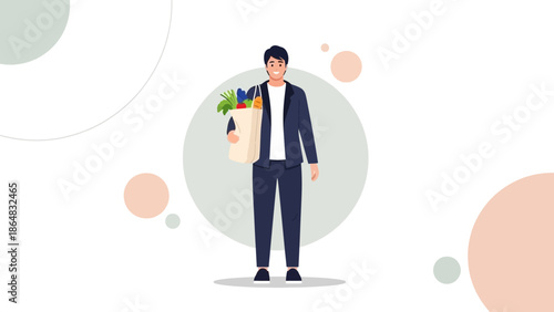 Young man holding a reusable shopping bag filled with fresh produce standing against a minimal
