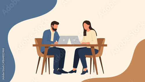 Two professionals working together in a modern office setting with laptops and minimalistic decor