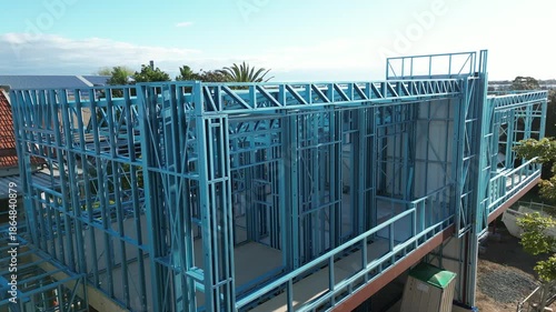 Steel frame house under construction, modern residential building site
