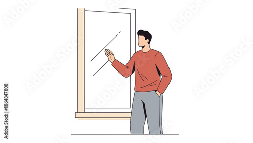 Young man standing near window looking outside contemplatively in a minimalistic modern interior