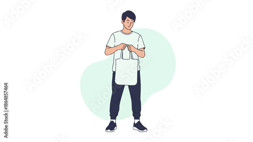 Young boy standing confidently while holding a tote bag and looking at his smartphone during a