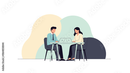 professional meeting or interview with two individuals working on laptops collaboratively