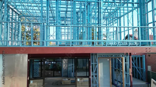 Steel frame house under construction, modern residential building site
