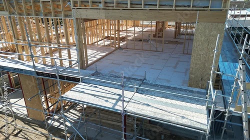 Wooden house frame under construction, timber structure residential building site
