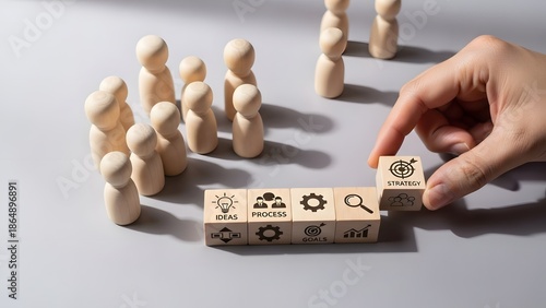 Hand arranging strategic business process blocks, symbolizing structured planning, idea development, and problem-solving for project implementation and team collaboration
