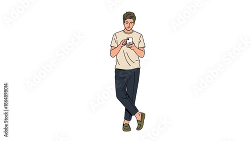 Young man standing with crossed legs, casually using smartphone in relaxed pose